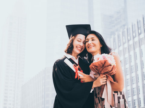 Beautiful woman congratulates for her daughter on graduation day, Successful concept