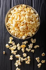 Wandaufkleber popcorn cheese in a bowl closeup. Vertical top view © FomaA