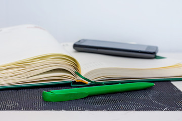 Notebook, pen and phone - means of recording information during   lecture at a school or college, university_