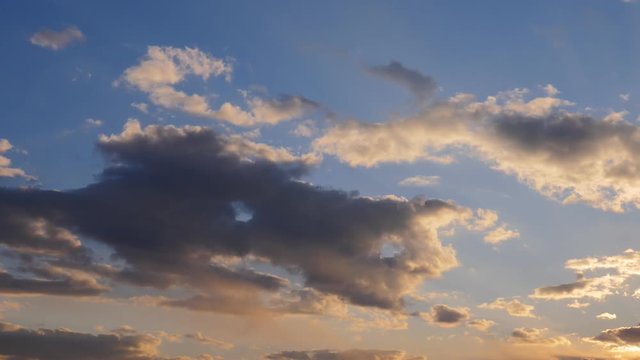Moving clouds on sky at sunset. Nature background.