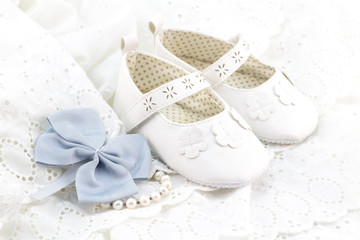 Baby white baptism or birthday dress and shoes close up with space for text