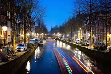 Fototapeta premium Amsterdam , view of Leidsegracht canal at night. It can be seen at center the bell friar of the Catholic Church