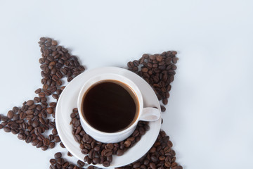 Coffee cup and beans on old kitchen table. Top view with copyspa