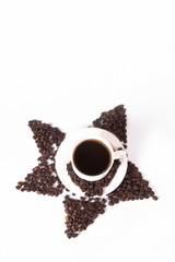 Coffee beans in the shape of a star with a cup. Top view with copyspace for your text