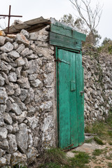 Very old weathered green door made of wood