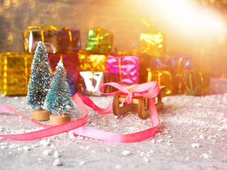 Christmas concept, toy santa sleigh, gift boxes on snow and blur bokeh, Empty wooden sled