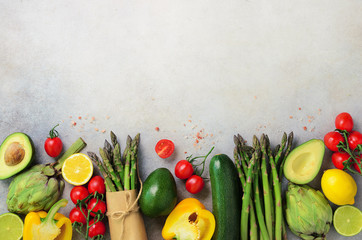 Different organic vegetables - asparagus, tomatoes cherry, avocado, artichoke, pepper, lime, lemon,...