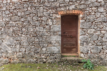 Fototapeta na wymiar Very old weathered brown door made of wood