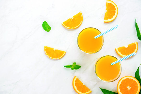 Refreshing drinks for summer, orange juice with ice cubes in the glasses