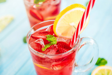 Strawberry lemonade juice with ice cubes in the glasses