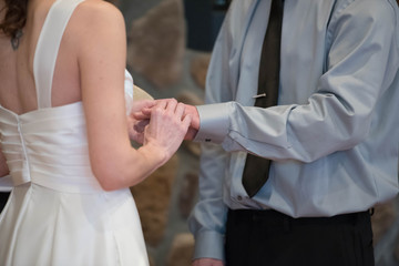 Bride and Groom Placing Rings on Each Other at a Wedding