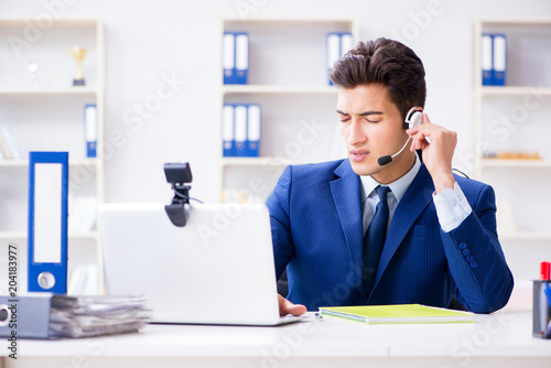 Young Help Desk Operator Working In Office Stock Photo And