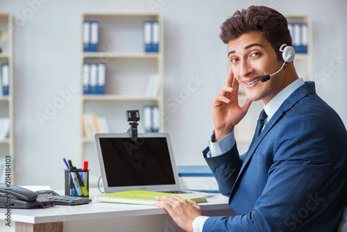 Young Help Desk Operator Working In Office Stock Photo And