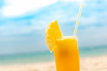 Refreshing tropical pieapple fruit juice drink at summer beach