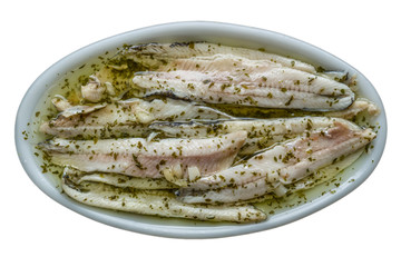 Anchovies in vinegar. Spanish typical appetizer. The anchovies are cleaned and macerated in a mixture of water and vinegar. Later they are covered with oil and garlic and parsley are added. 