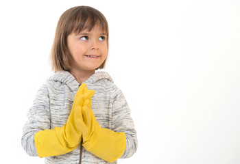 A little smiling kid in rubber gloves in the studio at the white isolated background.