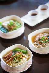 Bowls of pork noodle soup on the table