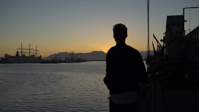 A young man watching a beautiful sunset alone in San Francisco.