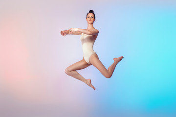 Obraz premium slim gymnast in beige swimsuit