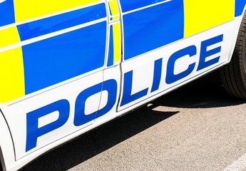 Large police sign on the side of a patrol car.