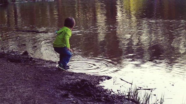 A child playing on the shore of thelake. Walks in the fresh air. A beautiful scenic place.