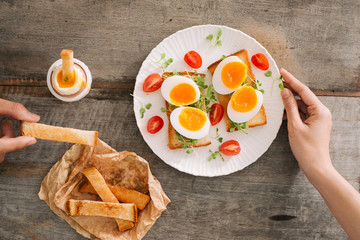 freshly boiled white egg on wooden board. Healthy fitness breakfast.