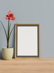 Frame on table with flower.