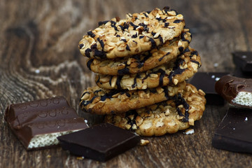 Chocolate assortment and sweets on a wooden background