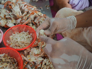 peeling shell boiled crab by man in factory