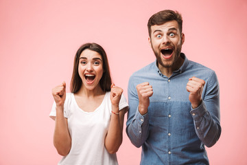 Portrait of an excited young couple screaming
