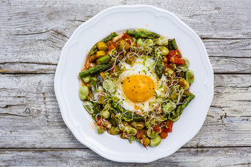 Fried shakshouka with seasonal vegetables asparagus and broad bean.

