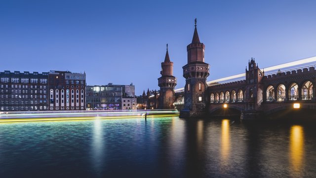 Berlin Oberbaum Bridge with traces of light from ship and train in the evening, Berlin, Germany, Europe