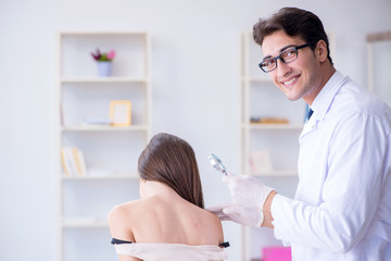 Fototapeta premium Doctor examining the skin of female patient