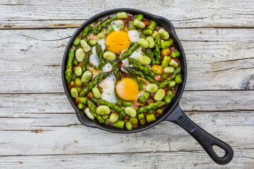 Fried shakshouka with seasonal vegetables asparagus and broad bean.

