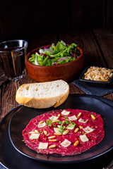 Carpaccio of beef with pine nuts, colorful pepper and Parmesan cheese