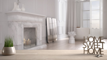 Wooden table, desk or shelf with potted grass plant, house keys and 3D letters making the words home sweet home, over minimalist bathroom, interior design, blur background