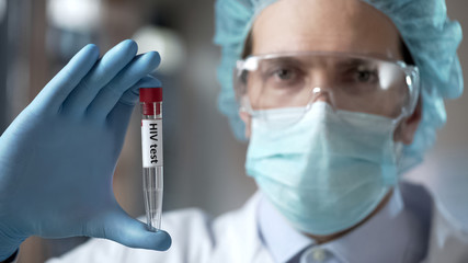 Laboratory expert holding blood test for HIV antibodies, infection prevention