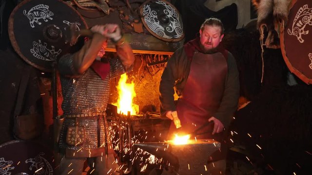 The smiths at work. The process of making an ax