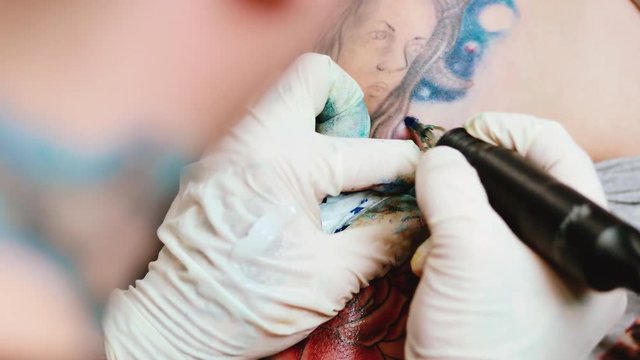 Tattoo artist make tattoo at the studio. Close up