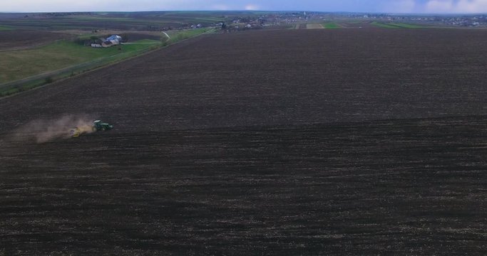 Aerial view of the tractor sowing seed on the field. 4K