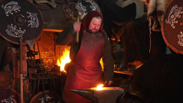 The smith viking working hard in a smithy