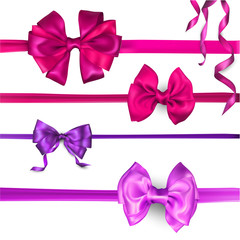 Purple, pink and lilac satin bows isolated on white.