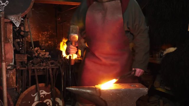 The smith viking working hard in a smithy