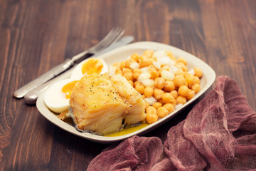 cod fish with chick pea and boiled egg on dish