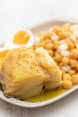 cod fish with chick pea and boiled egg on dish