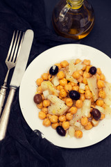 cod fish with chick pea and olives on dish