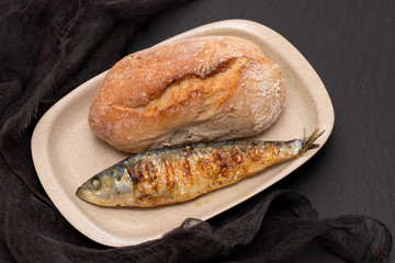 grilled sardine with bread on dish