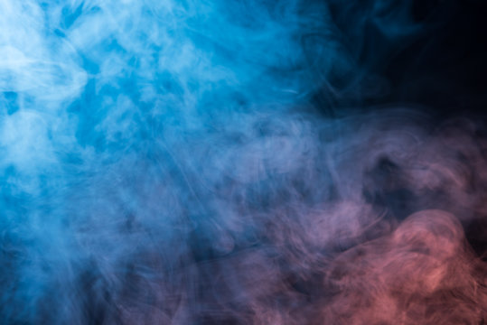 Abstract blue and pink smoke on a dark background © vbaleha