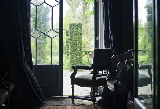 Empty old chair by the open backyard door