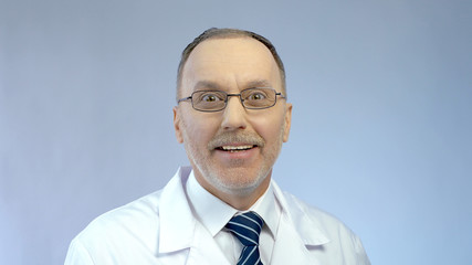 Excitement on happy face of male doctor surprised by good career opportunity